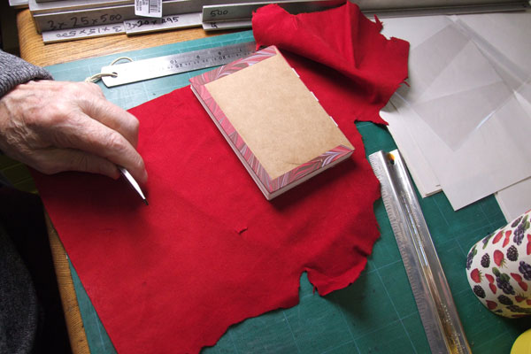 Peparing a leather cover for a small book