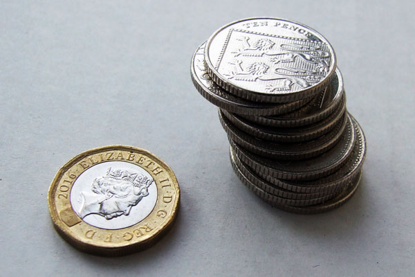 A pound coin with pennies