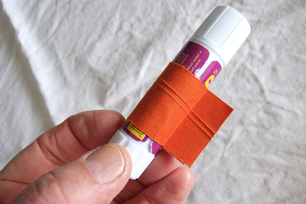 Glue stick with tape to prevent rolling