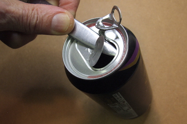 A steel folder being used to prise open a can
