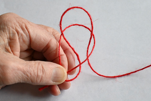 Demonstrating how to make a simple slip knot