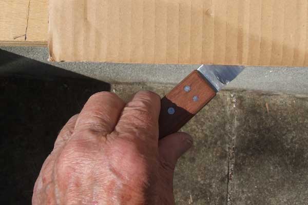 Cutting a cardboard box with a cobbler's knife